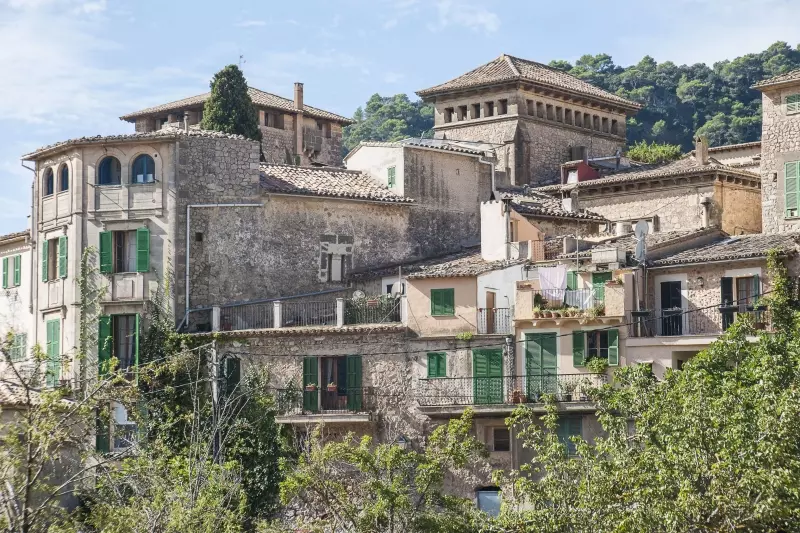 Historische Häuser in Valldemossa vor bewaldeter Bergkulisse